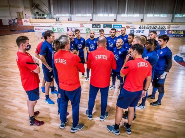 Otto Orf (second in red shirt from left) and other coaches address the U.S. Men's Futsal National Team before a game in Slovakia. (Submitted by Otto Orf).